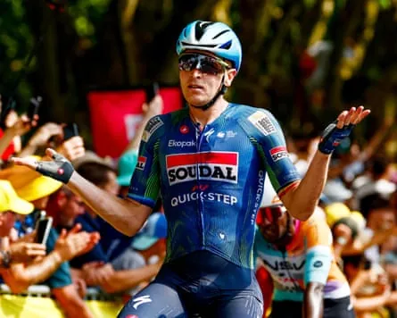 Tim Merlier shrugs his shoulders in delight after his stage victory